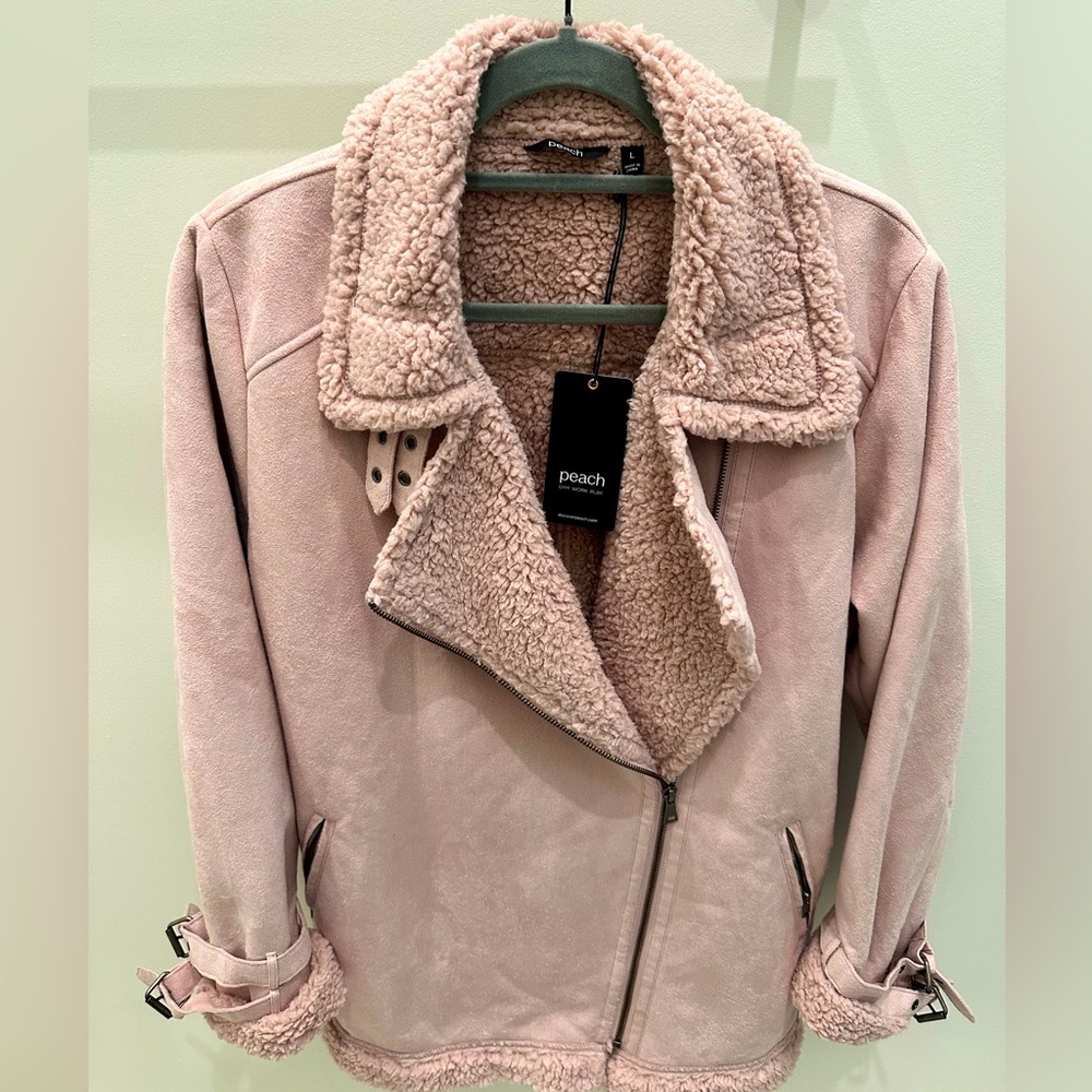 Faux suede jacket with warm fuzzy lining.  Buckles at neck and sleeves. Pockets